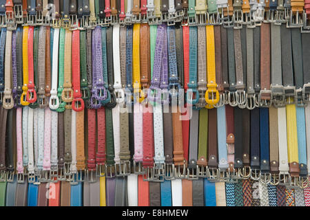 many colored leather belts on a market Stock Photo