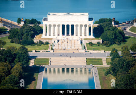 WASHINGTON DC, United States — The Lincoln Memorial and its Reflecting Pool are viewed from atop the 555-foot Washington Monument. This aerial perspective from the Monument's observation level reveals the classical symmetry of the National Mall's western end. The Washington Monument, completed in 1884, provides this unique vantage point of the capital's monumental core. Stock Photo