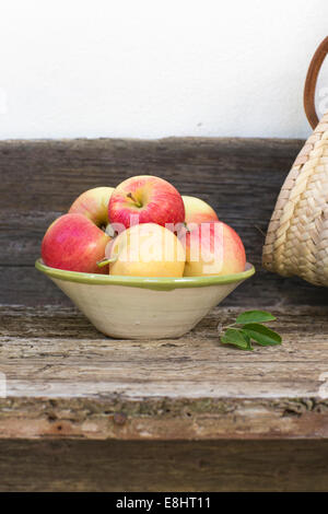 apples, red, green, fruit, autumn, rustic bench, white background, outdoors, in hand painted ceramic bowl,  juicy, fresh, health Stock Photo