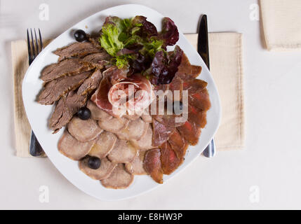 Overhead of Assorted Cold Meat Plate at Place Setting Stock Photo