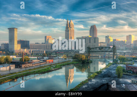 The Terminal Tower and Key Tower, lit by early morning light are reflected in the Cuyahoga River in Cleveland, Ohio. Stock Photo