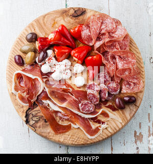 Cold meat plate and olives on wooden background Stock Photo