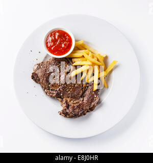 Roast beef with Salted french fries on white plate on white background Stock Photo