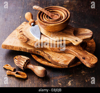Olive wood tableware on dark wooden background Stock Photo