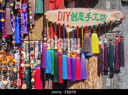 LIJIANG,CHINA - SEPTEMBER 16, 2014: hand made Naxi's souvenirs in the small shop of Lijiang, China on September 16, 2014. Stock Photo