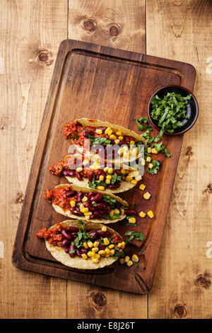 Tacos with ground beef, corn and red beans on wooden table Stock Photo