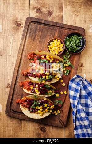 Tacos with ground beef, corn and red beans on wooden table Stock Photo