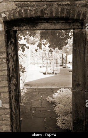 Infrared photograph of a classic English garden, view through open doorway at Wollerton Old Hall (NGS) Market Drayton in Shropsh Stock Photo