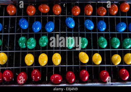 Brightly coloured Easter eggs on a conveyor belt, Beham egg dyeing company, Thannhausen, Bayern, Germany Stock Photo