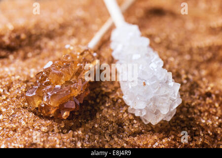 White and brown rock sugar sticks over heap of broun gugar Stock Photo