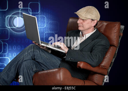 Man sitting indoors using laptop on tech background - clipping path Stock Photo