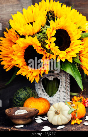 Sunflowers and Autumn decorations on wooden background Stock Photo