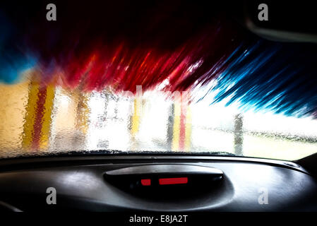 Motion blurred picture of car wash from inside a car during the wash. Stock Photo
