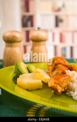 chicken served with white rice potato on a plate Stock Photo