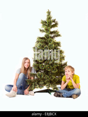 Boy and girl sitting under the tree Stock Photo - Alamy