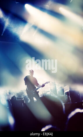 Rock concert stage. Guitarist playing on electric guitar. Stock Photo