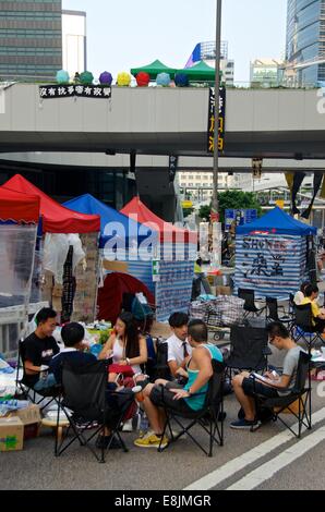 Hong Kong. 9th October, 2014. Young people rest on the 12th day of the pro-democracy protest known as 'Occupy Central', blocking traffic on major roads in downtown Hong Kong. The mood continues to be mostly peaceful, although inconvenienced residents are increasingly angry with the blocked streets. The Occupy Central civil disobedience movement began in response to China's decision to allow only Beijing-vetted candidates to stand in the city's 2017 election for the top civil position of chief executive. Credit:  Stefan Irvine/Alamy Live News Stock Photo