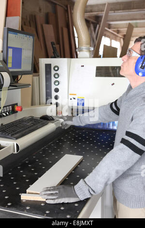 Man operating factory saw Stock Photo