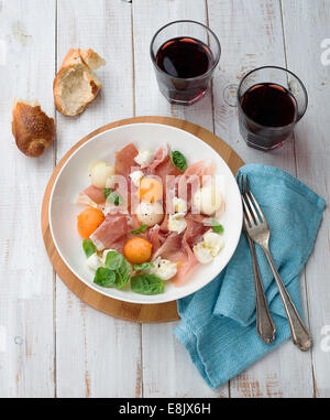 Melon and prosciutto ham salad with Mozzarella Stock Photo