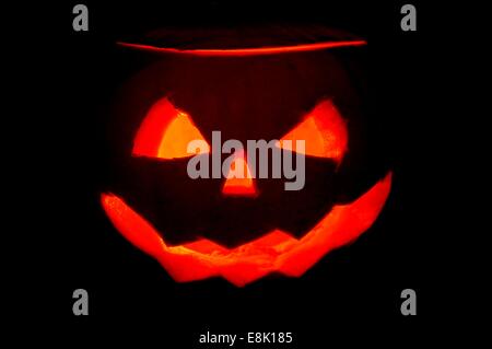 A glowing Halloween pumpkin face Stock Photo