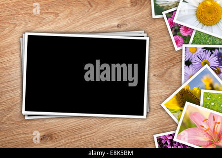Stack of printed pictures collage on wooden table with copy space for your photo Stock Photo