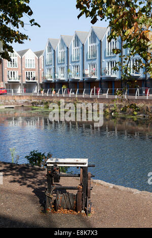 Old winch beside the canal with modern apartments in the background, Chichester, West Sussex Stock Photo