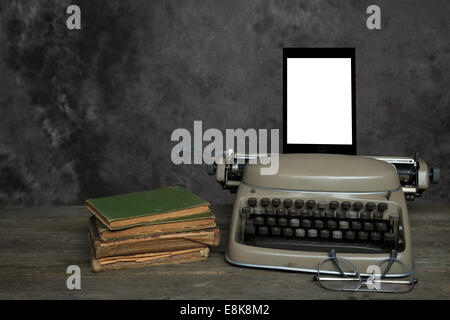 Old typewriter, old books, reading glasses and an self-designed E-Reader with blank display for your text Stock Photo