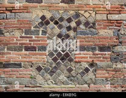 Fragment of the ancient masonry in the modern brickwall Stock Photo