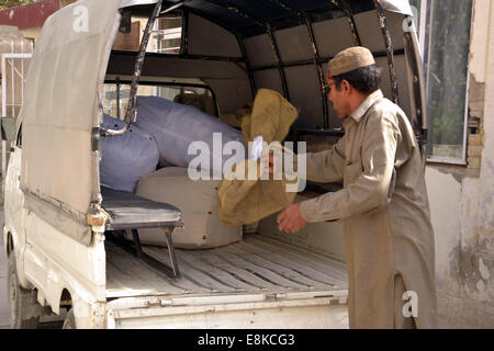 Quetta. 9th Oct, 2014. A Pakistani postman collects mails in a vehicle on the World Post Day in southwest Pakistan's Quetta on Oct. 9, 2014. World Post Day is celebrated each year on Oct. 9, the anniversary of the establishment of the Universal Postal Union (UPU) in 1874 in Berne, the Swiss capital. © Asad/Xinhua/Alamy Live News Stock Photo