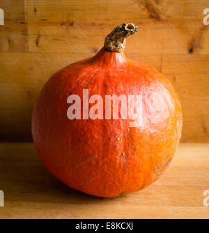 Fresh orange Hokkaido pumpkin on wooden background Stock Photo