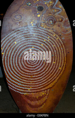 Ceramic painted shield in the Australian Aboriginal style showing a spiral. Australian Indigenous art is oldest unbroken trad' Stock Photo