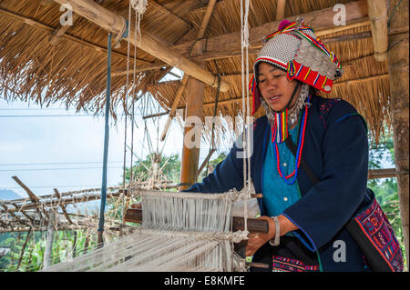 Traditionally dressed woman from the Akha people, hill tribe, ethnic minority, working on a loom, Chiang Rai Province Stock Photo