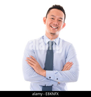 Handsome Asian business man smiling, standing isolated over white background. Stock Photo
