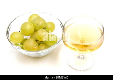 Glass of wine and grapes on bowl on white background Stock Photo
