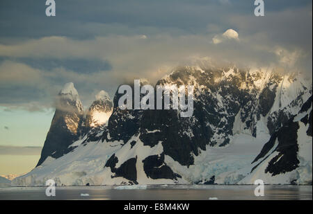 Sunset on peaks above Lemaire Channel, Antarctic Peninsula, Antarctica Stock Photo