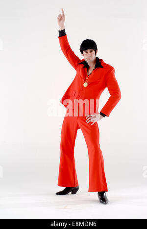 man in fancy dress comedy costume as a 1970s disco john travolta staying alive disco fashion outfit Stock Photo