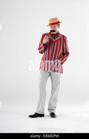 man in fancy dress comedy costume as a barber shop quartet singer with a hudsucker jacket and straw hat Stock Photo