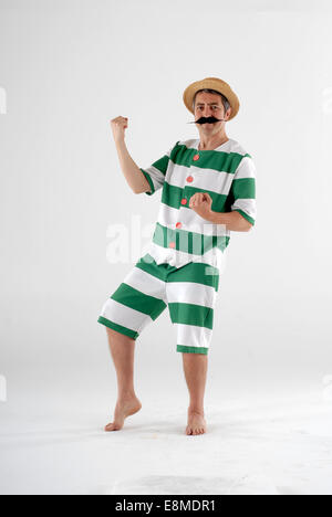 man in fancy dress comedy costume in a victorian old fashioned swimmer with proper swimming outfit Stock Photo