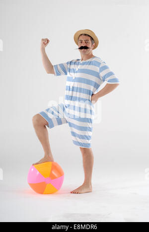 man in fancy dress comedy costume in a victorian old fashioned swimmer with proper swimming outfit Stock Photo