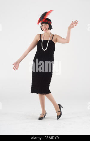 Lady in 1920s flapper dress costume waiting for the steam train on a ...