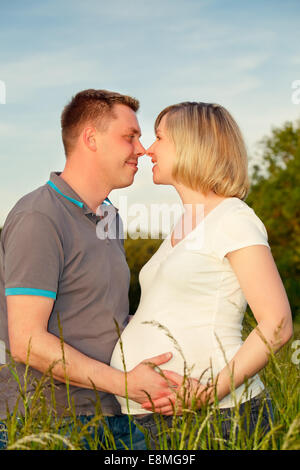 Pregnant couple in the park Stock Photo