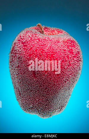 Bright red apple covered in tiny bubbles Stock Photo