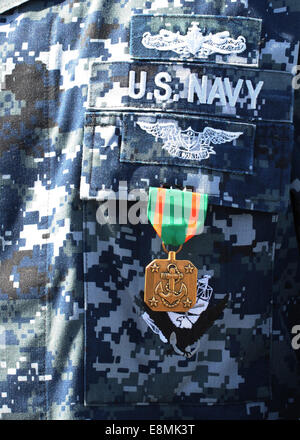 A Navy and Marine Corps Achievement Medal adorns the U.S. Navy uniform. Stock Photo