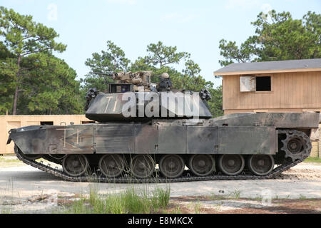 August 17, 2014 - An M1A1 Abrams tank takes a defensive position while conducting an assault on a simulated enemy town at Camp L Stock Photo