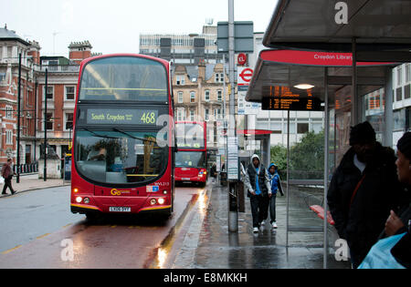 Buses in wet weather, Croydon, South London, UK Stock Photo