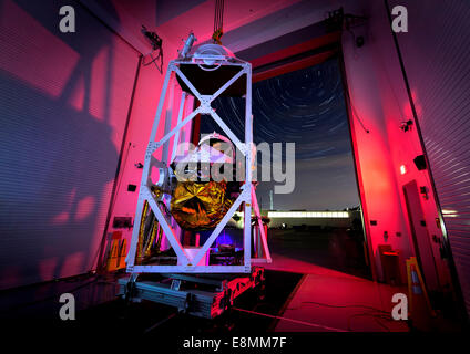 A 5,200-pound balloon gondola hangs from a crane and moves toward the open doors of a building at the Johns Hopkins University A Stock Photo