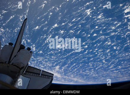 Space Shuttle Discovery backdropped by a blue and white Earth Stock ...