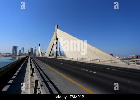 The Sheikh Isa bin Salman Causeway  with the World Trade Centre building in the distance, Kingdom of  Bahrain Stock Photo