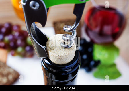 Corkscrew opening a bottle of wine Stock Photo