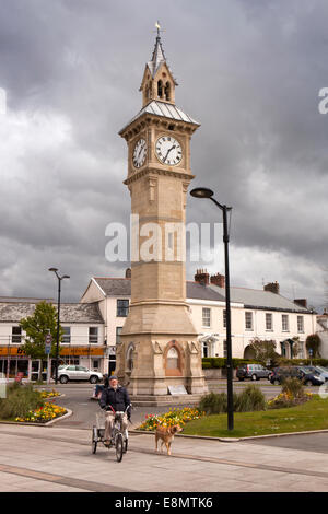 UK, England, Devon, Barnstaple The Square, man on tricycle cycling past Prince Albert Memorial clock tower Stock Photo